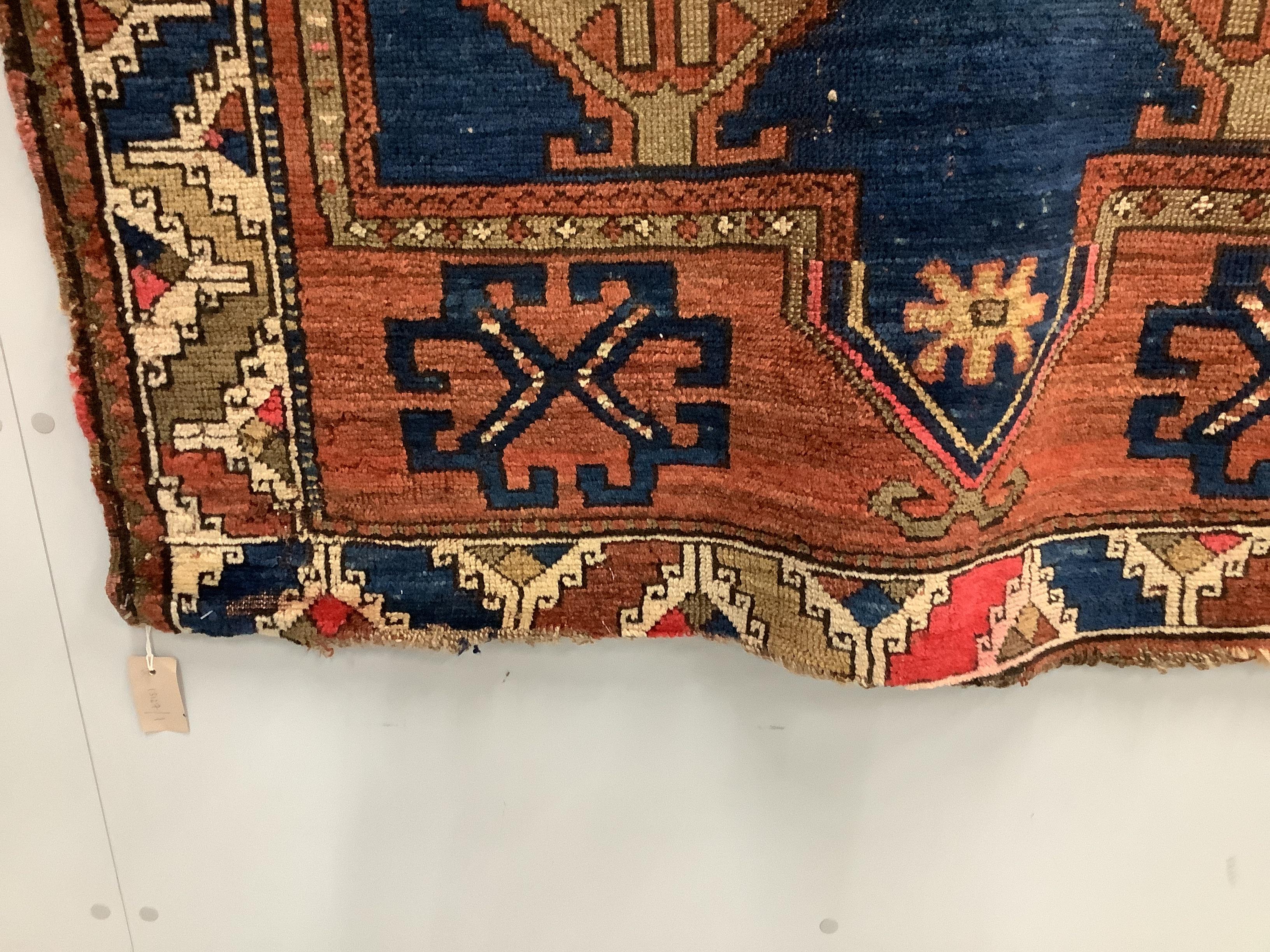 An antique Caucasian blue ground rug, 160 x 115cm